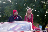 Desmond Reynolds and Lauren Wineman, members of the Royalty Court, greet the crowd who gathered in The Village to watch the homecoming parade